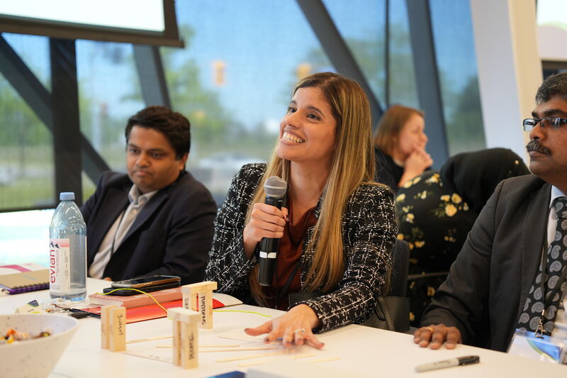 Panel speaker addressing the room with a microphone
