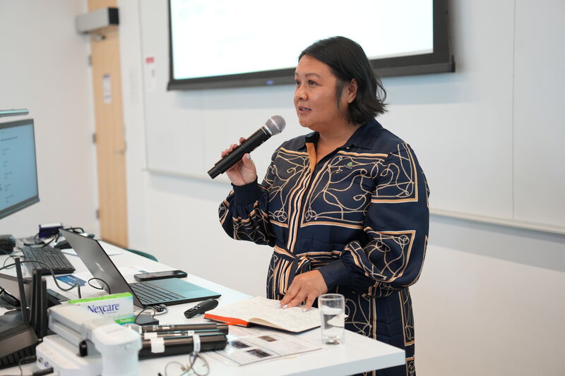 Speaker presenting to attendees at a symposium