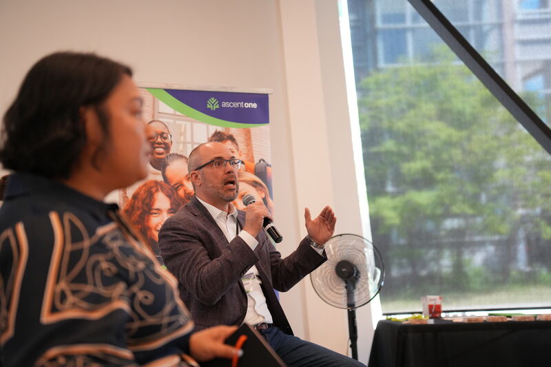 Panel discussion with an audience member asking a question