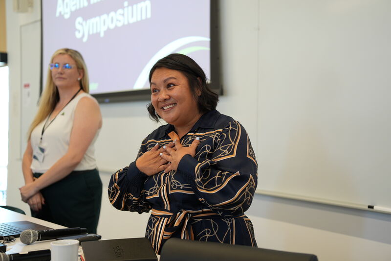Speaker smiling during a presentation